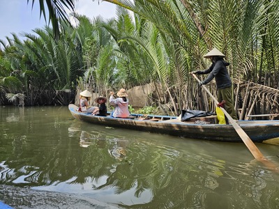 Riding a hand-rowed sampan through Thoi Son canal	